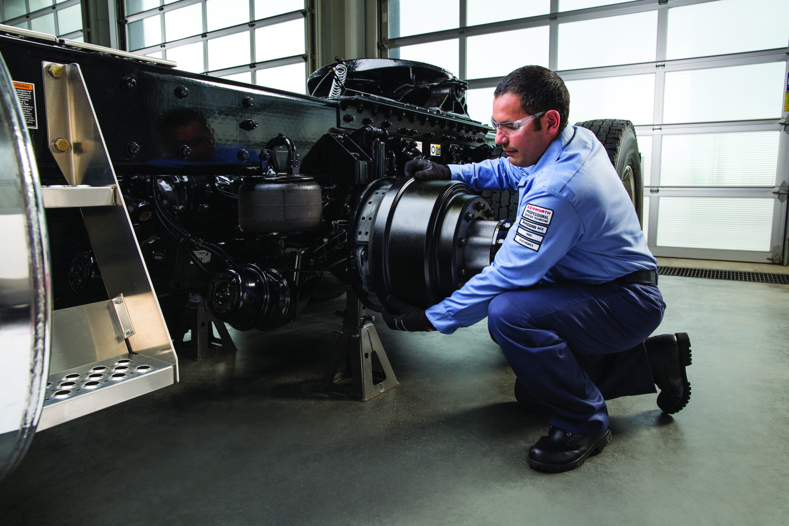 2025 Brake Safety Week. Service Technician putting a brake drum on a truck
