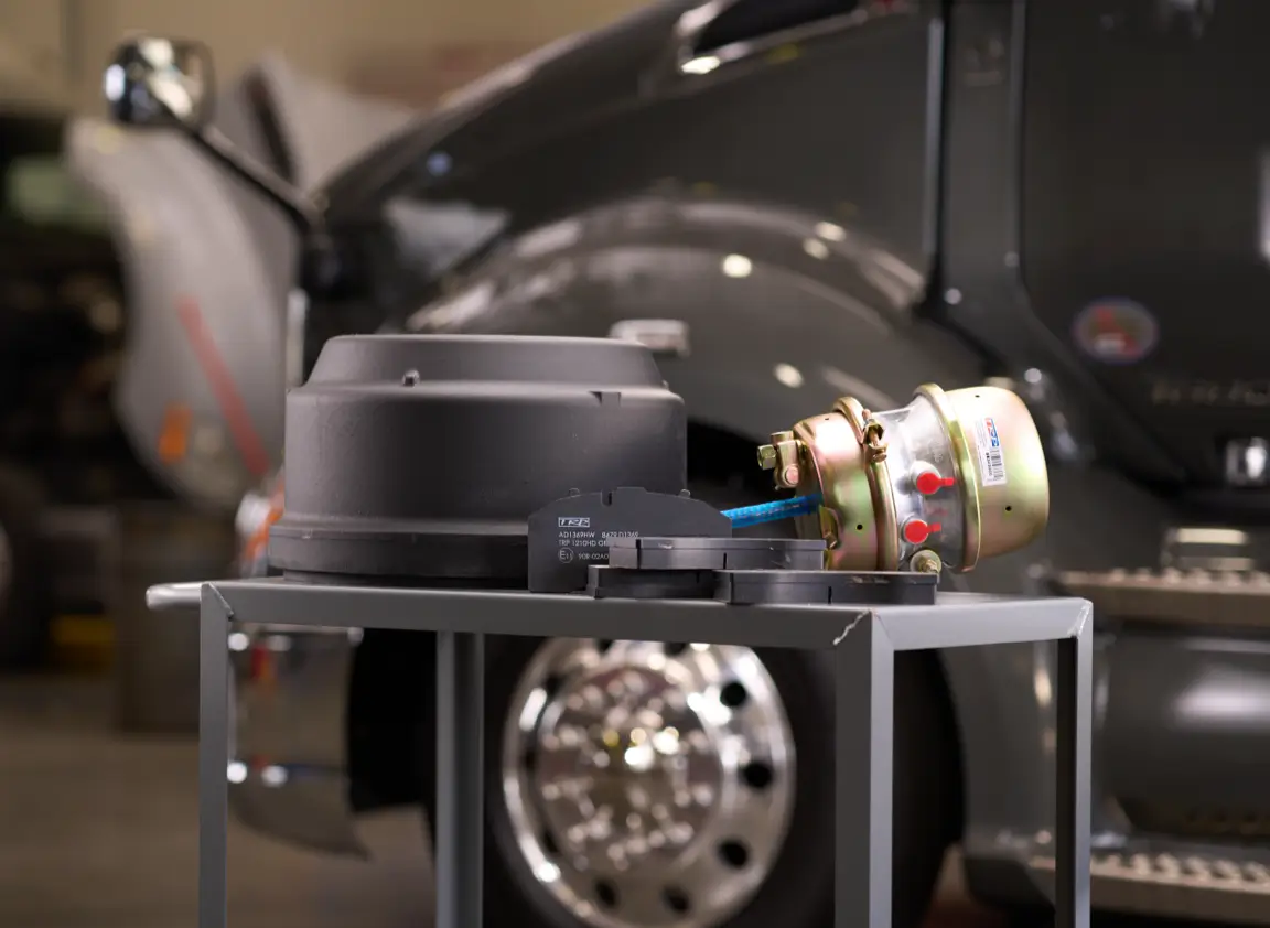 Heavy-Duty Truck Parts on a cart in front of a Kenworth Trruck