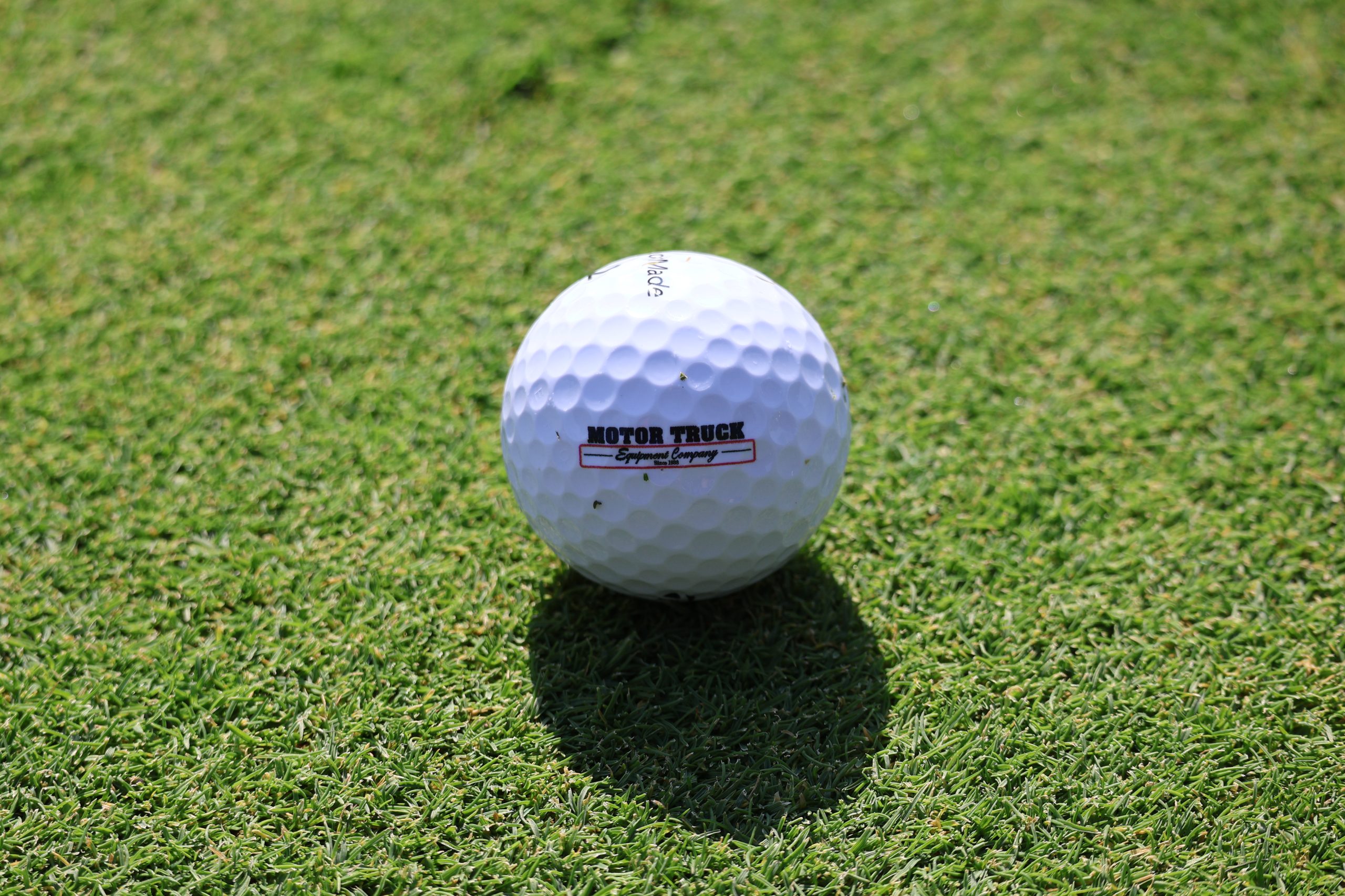 A Motor Truck Branded Golf Ball On The Green