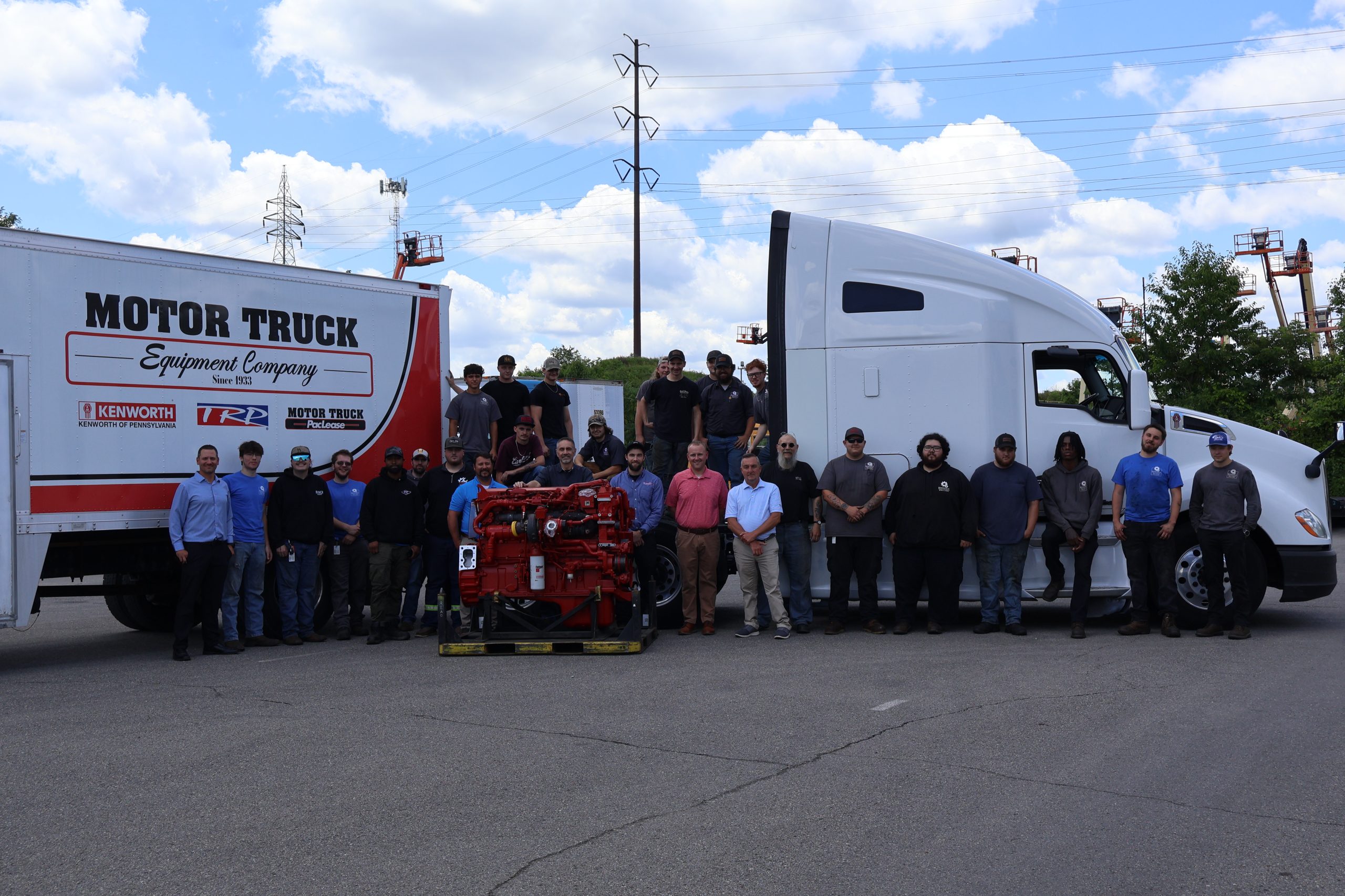 Students From Rosedale Technical College standing Behind a Cummins X15 Engine & Kenworth T680 Sleeper Truck